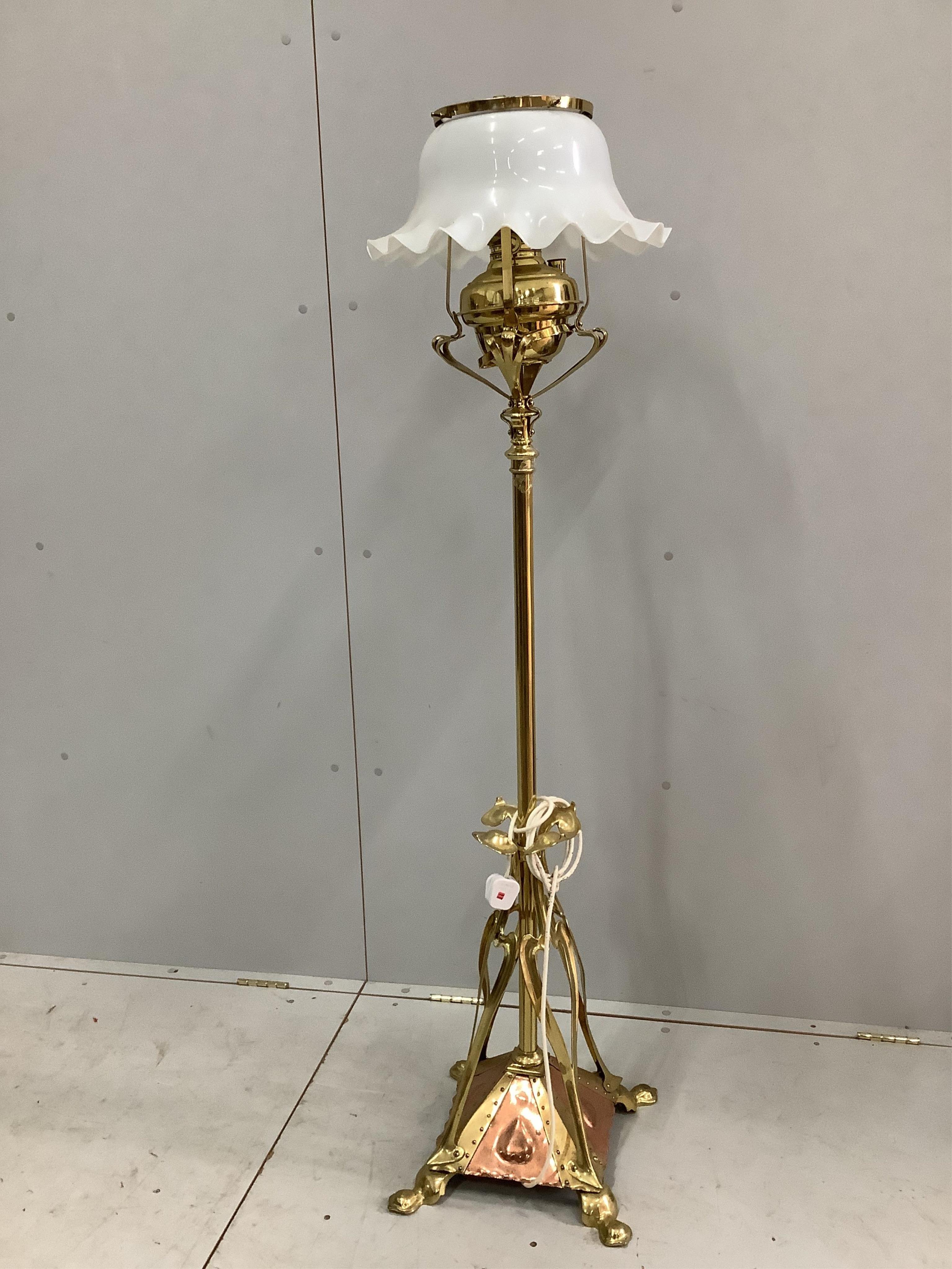 An Art Nouveau copper and brass telescopic oil lamp standard, in the manner of Benson, with opaque glass shade. Condition - good